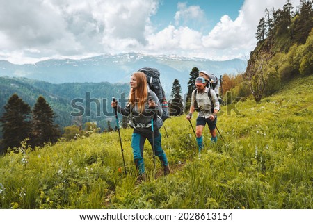 Family hiking in mountains travel adventure vacations group hikers couple with baby trekking outdoor healthy lifestyle eco tourism  Royalty-Free Stock Photo #2028613154