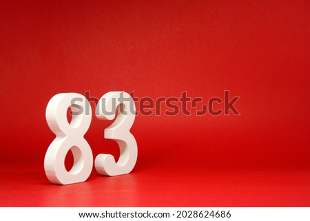 Eighty three ( 83 ) white number wooden Isolated Red Background with Copy Space - New promotion 83% Percentage   Business finance or birthday Concept - advertise banner picture online with copy space