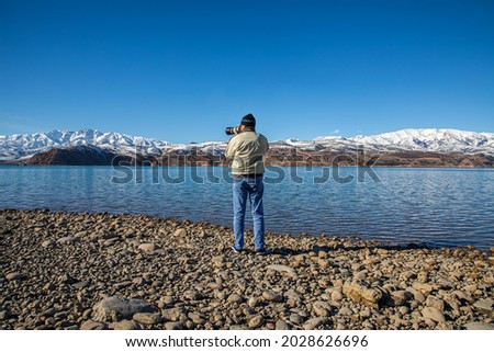 Photographer taking photo of a lake
