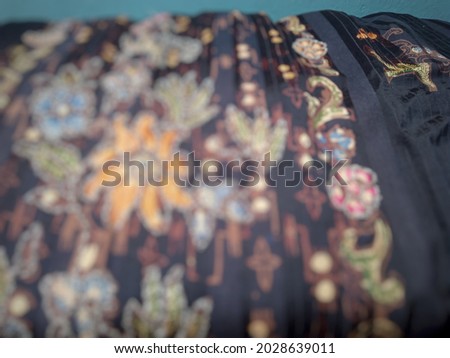 Defocused abstract background of traditional Indonesian textile fabric surface.