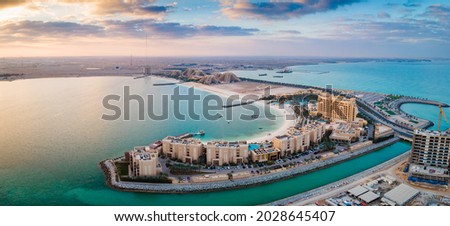 Panoramic view of Marjan Island seafront reclaimed land artificial island in emirate of Ras al Khaimah in the United Arab Emirates aerial view at sunrise Royalty-Free Stock Photo #2028645407