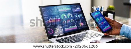African Advisor Using KPI Dashboard With Financial Analytics Graphs Royalty-Free Stock Photo #2028661286