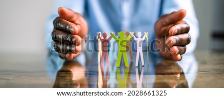 Inclusion, Diversity And Equality. African Hands Safeguard Paper Shapes Royalty-Free Stock Photo #2028661325