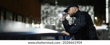 Security Guard Man At Night. Building Alley Patrol Royalty-Free Stock Photo #2028661904