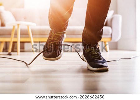 Wire Cord Trip Over And Fall. Feet Stumble On Cable Royalty-Free Stock Photo #2028662450