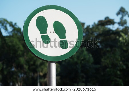 Photo of a pedestrian symbol in a city park