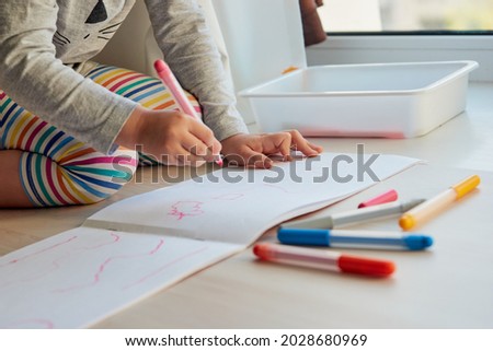3 years girl draws a picture. Child at home, kindergarden and preschool closed during Covid-19
