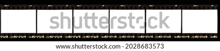 real scan of 35mm negative film strip on black background with white or empty frames for your content. retro photo placeholder. film border. Royalty-Free Stock Photo #2028683573