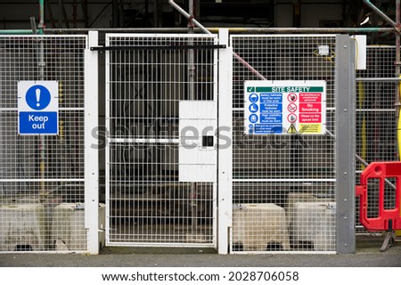 Access gate to construction site and health and safety message rules sign board signage