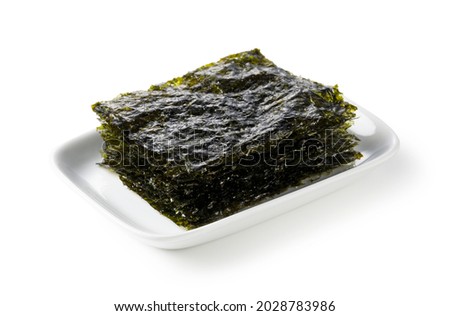 Korean seaweed on a plate set against a white background. Royalty-Free Stock Photo #2028783986