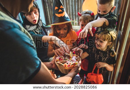 Children celebrate Halloween dressed up in costumes. Selective focus. Kids. Royalty-Free Stock Photo #2028825086