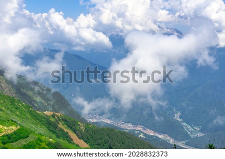 Beautiful Summer sunny mountains with clouds and meadow