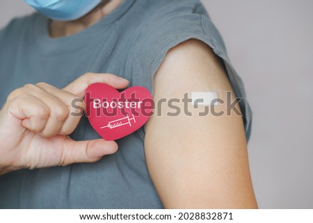 senior woman show red heart shape with syringe icon,  after vaccinated or inoculation  booster dose  due to spread of corona virus, population, social or herd immunity concept Royalty-Free Stock Photo #2028832871