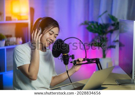 singer women singing with headphone recording new song in the home recording studio