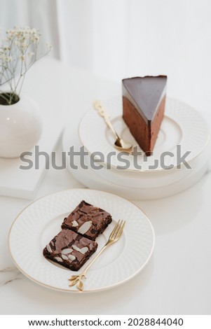 Double Rich brownies cake and Rich premium sliced Chocolate mousse cake on the white plate in the white background