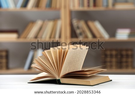 Open book on white table in library