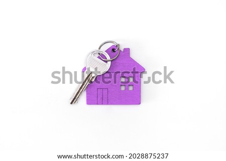 figure of a mini house of purple color with keys on an isolated white background.
