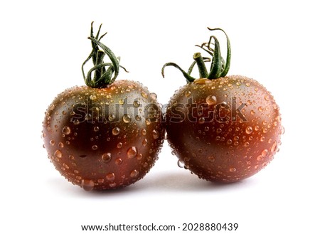 Tomatoes cherri cumato close-up isolated on a white background. Black tomato. Royalty-Free Stock Photo #2028880439