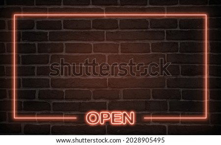 open neon sign. red glow. neon text. Brick wall lit by neon lamps. Night lighting on the wall. Trendy Design. light banner, bright advertisement