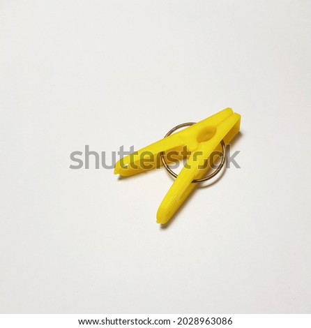 The yellow clothespin is on a white background.