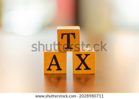 The word Tax and blur background,The word on wood square cubes,Concept word cubes, Wooden box
