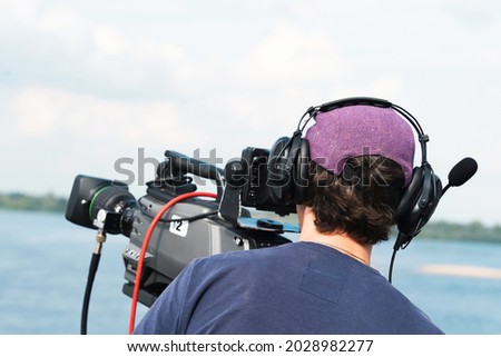 A videographer with professional equipment is filming a plot for television. Preparation of a documentary film for mass broadcast. Close-up. Unrecognizable person