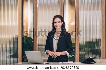 Smile Receptionist welcome   at hotel front desk Royalty-Free Stock Photo #2028990590