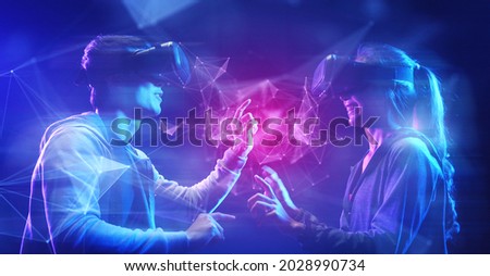 Future digital technology cyber virtual game entertainment metaverse, Teenager having fun play game VR virtual reality goggle, sport game 3D cyber space futuristic metaverse NFT game background,  Royalty-Free Stock Photo #2028990734