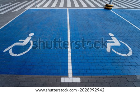 Handicapped symbol painted on a special parking space for disabled people