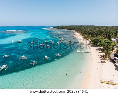 Daku Island white sand beach in Siargao Island Surigao del Norte Mindanao Philippines with turquoise blue sea water on a sunny day island hopping Royalty-Free Stock Photo #2028994541
