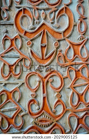 Carved patterns and symbols in the beautiful traditional Asmat Papuan carving style. This engraving pattern is very suitable for design, information and needs in the field of traditional style art etc Royalty-Free Stock Photo #2029005125
