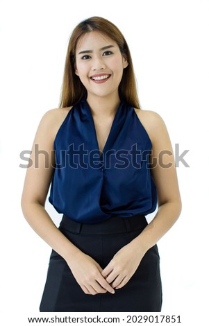 Attractive cutout portrait of a beautiful, healthy young Caucasian, Asian woman on a blue casual tank top and black slacks standing with hand holding, smiling, and good looking eye expression of happy