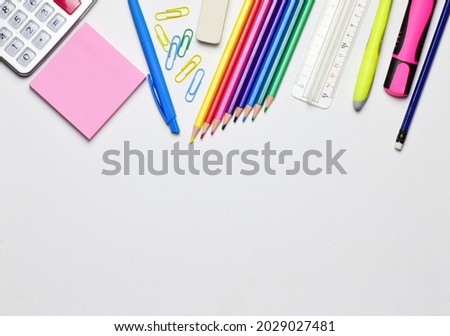 Variety of material, back to school.  Copy space and light background.