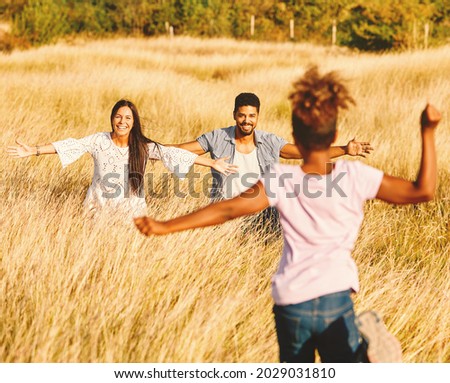 Family having fun playing and running outdoors