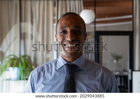 Profile picture of smiling young African American businessman look at camera show confidence leadership. Headshot portrait of happy motivated confident mixed race male employee or boss in office. Royalty-Free Stock Photo #2029043885
