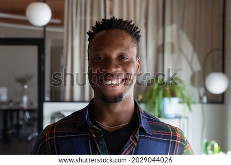 Headshot portrait of happy millennial mixed race ethnicity male employee pose in office. Profile picture of smiling young African American businessman feel motivated at workplace. Diversity concept.