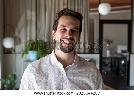 Headshot portrait of smiling young Caucasian man employee worker show confidence and success at workplace. Profile picture of happy businessman pose in office. Employment, leadership concept. Royalty-Free Stock Photo #2029044209