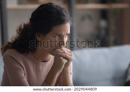 Close up upset face of young Latina woman deep in sad thoughts. 30s female looks aside feels unhappy goes through divorce, unplanned pregnancy and abortion decision, life troubles and problems concept Royalty-Free Stock Photo #2029044809