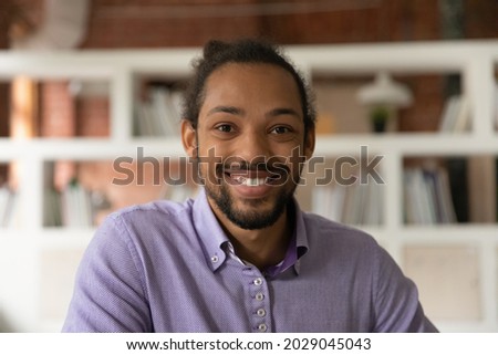 Head shot portrait African 30s man smile look at camera, profile picture of guy, webinar participant, stream video call event virtual meeting for business, fun, personal distance communication concept Royalty-Free Stock Photo #2029045043