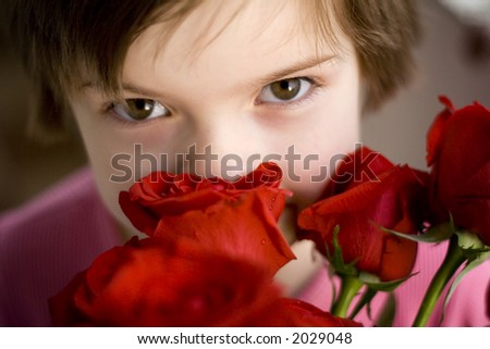 Cute girl smelling red roses