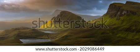Dramatic mountains of the Isle of Skye seen from viewpoint on the Quiraing. Large panorama with dark moody clouds. Scotland landscapes, UK.