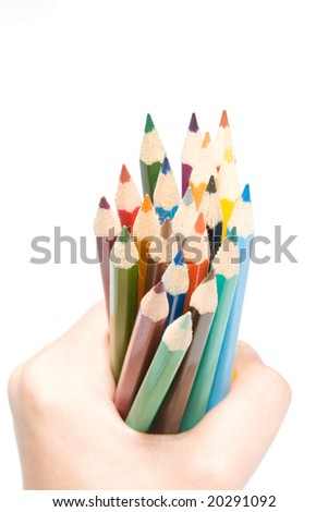 Girl holding several colored pencils on white