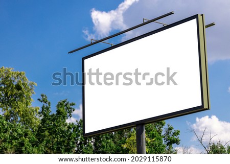 blank advertising billboard mockup. urban life. near park area. template for design. large advertising road banner.