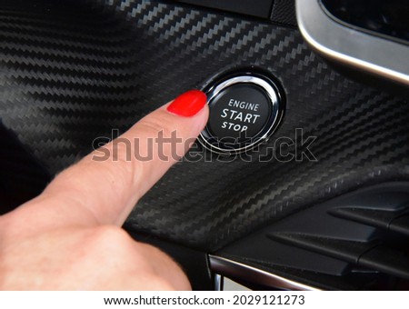 Women activates button to start and stop for car engine Royalty-Free Stock Photo #2029121273