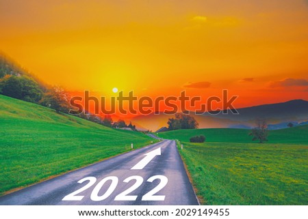 Open empty road path end and new year 2022. Upcoming 2022 goals and leaving behind 2021 year. passing time future, life plan change, work start run line, sunset hope growth begin, go forward concept. Royalty-Free Stock Photo #2029149455