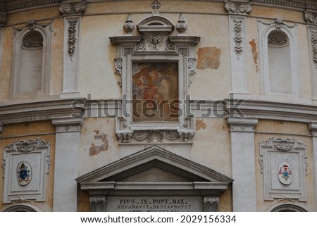 antique religious icon and sign on building wall italy