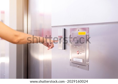 Woman finger pressing the elevator button,Modern lift panel