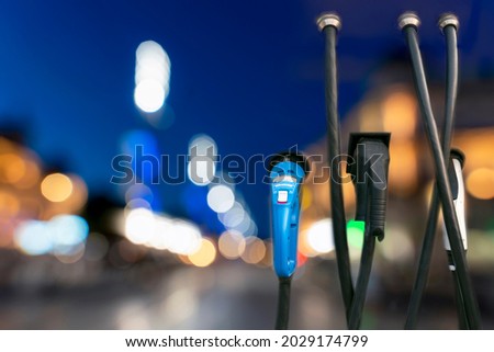 EV Car charging station with a background of blurred car lights
 Royalty-Free Stock Photo #2029174799
