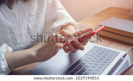 Woman using a smart phone in the office.