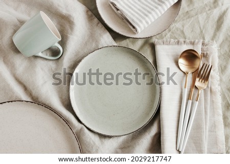 Ceramic plates mockup on  modern minimal table place setting neutral beige color top view.  Space for text or menu .Scandinavian style tableware. Business food brand template. Royalty-Free Stock Photo #2029217747